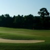 A view of a green protected by an undulating bunker at Peninsula Golf & Racquet Club
